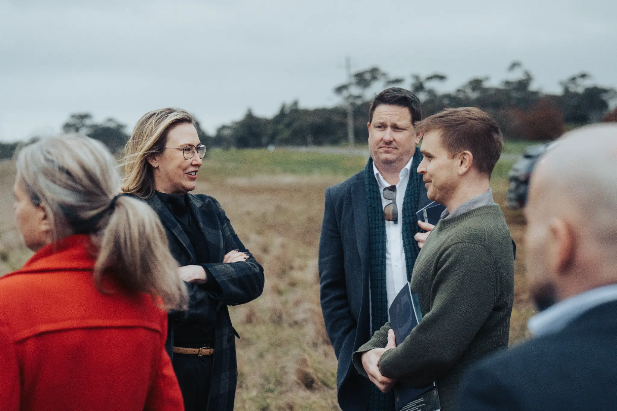 Colleagues in conversation outdoors at a Victoria event