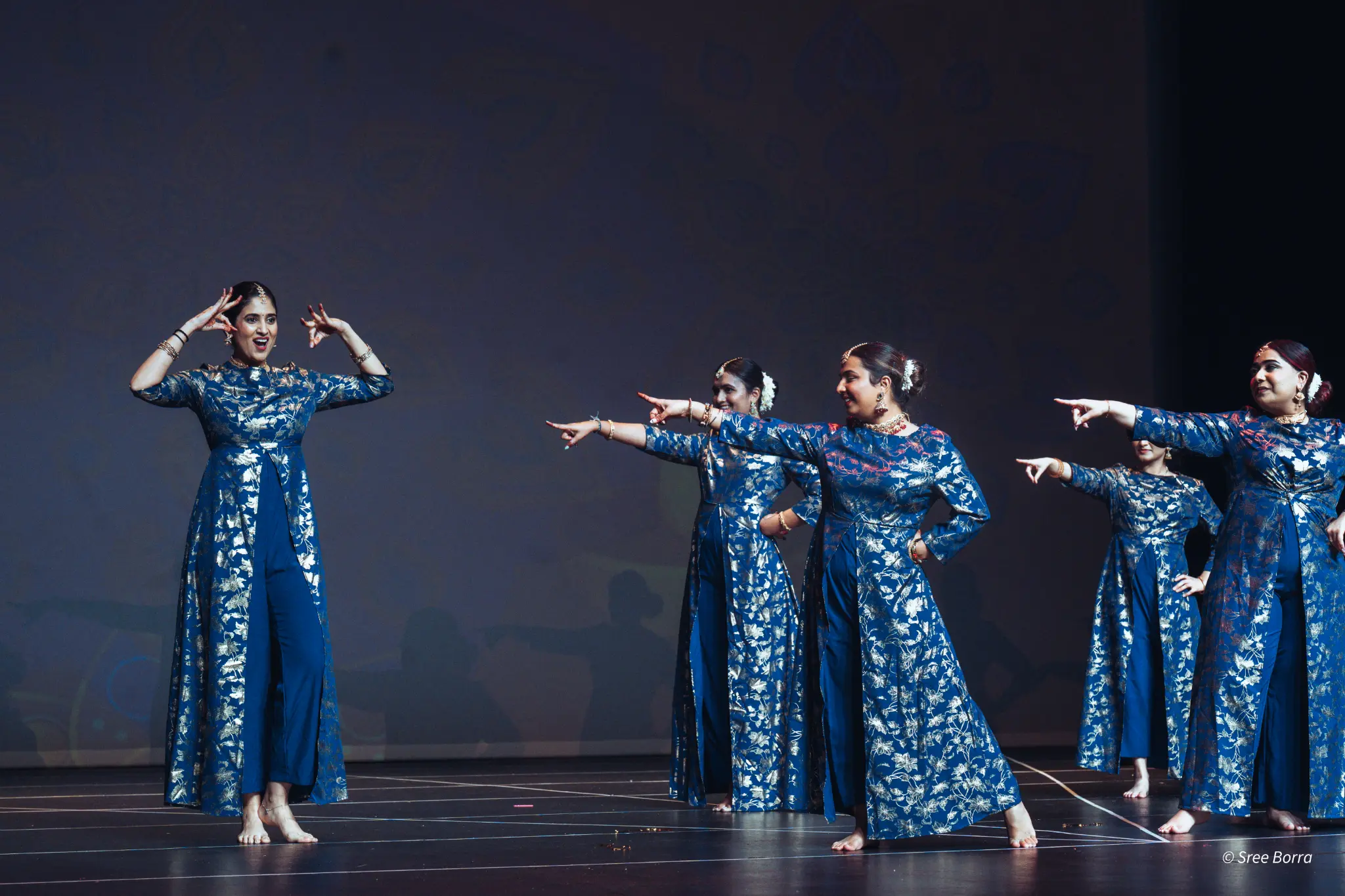 Blue-costumed dancers performing at a Melbourne event