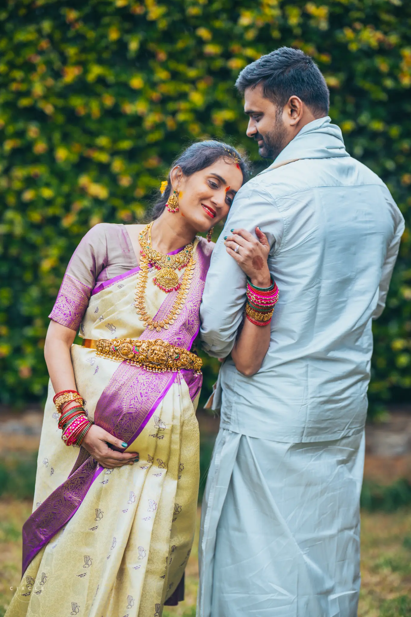 Expectant couple sharing a quiet outdoor portrait moment photographed by The Circle Studio